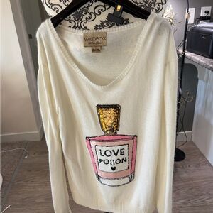 WILDFOX - V-Neck Sweater with Pink and Gold Perfume Design